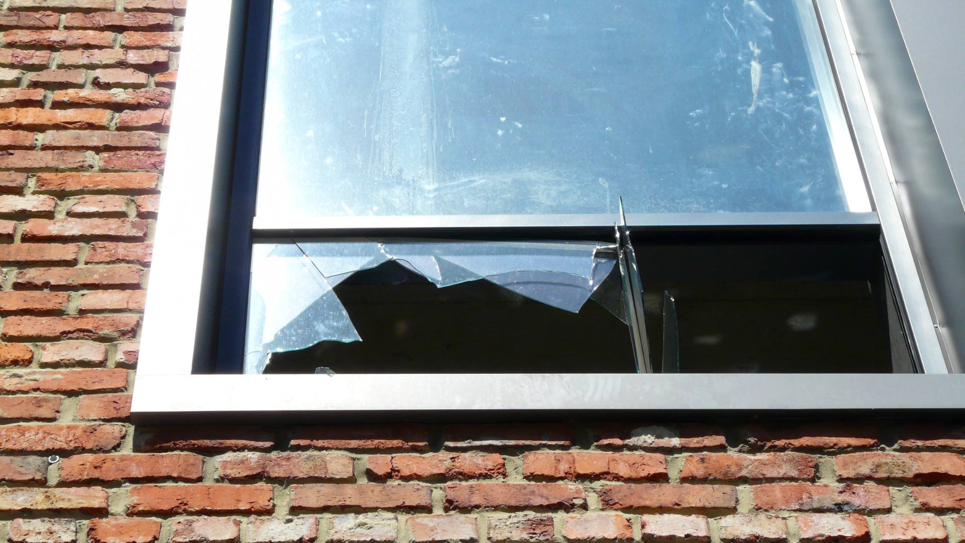 New white-framed window installed in a brick building exterior