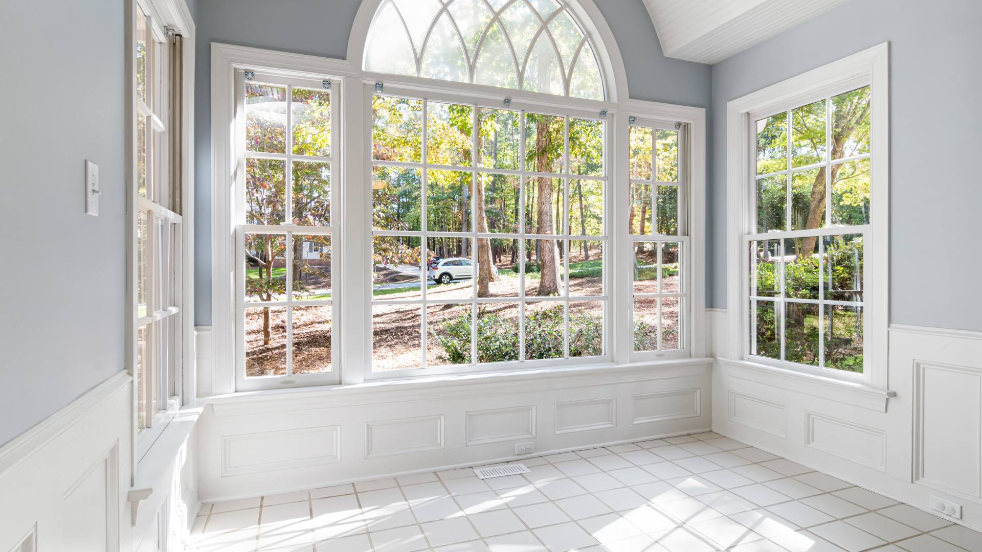 Bright interior with large windows framing a tree-lined view