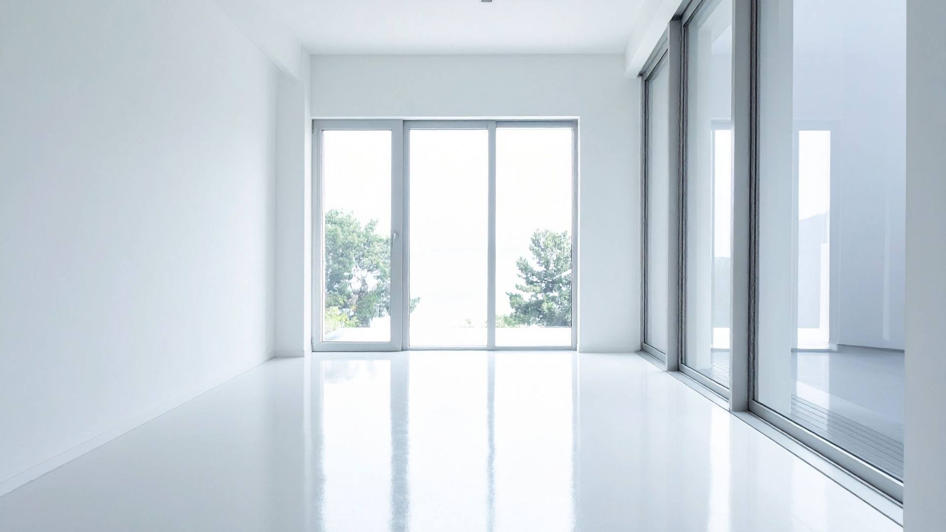 Large frameless gray glass doors in a minimalist interior