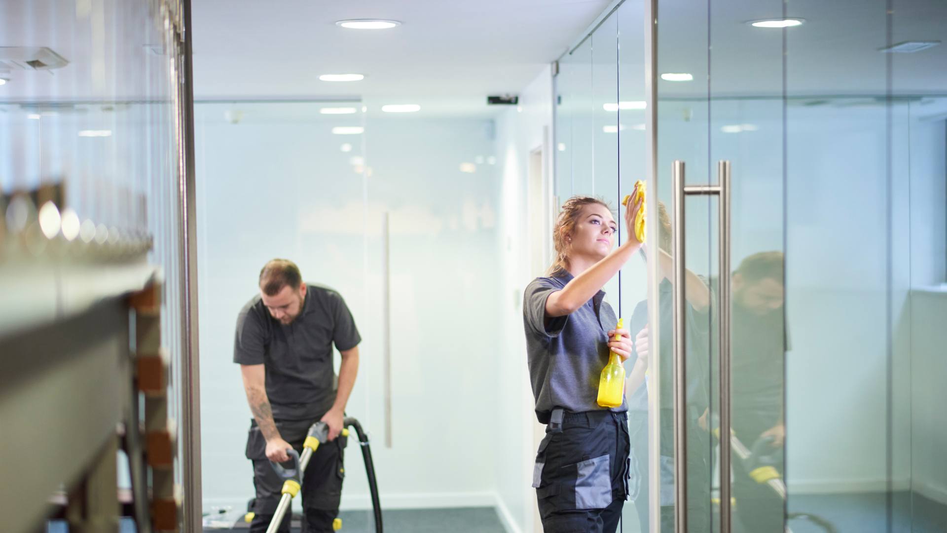 Frameless glass doors and panels in a modern office corridor