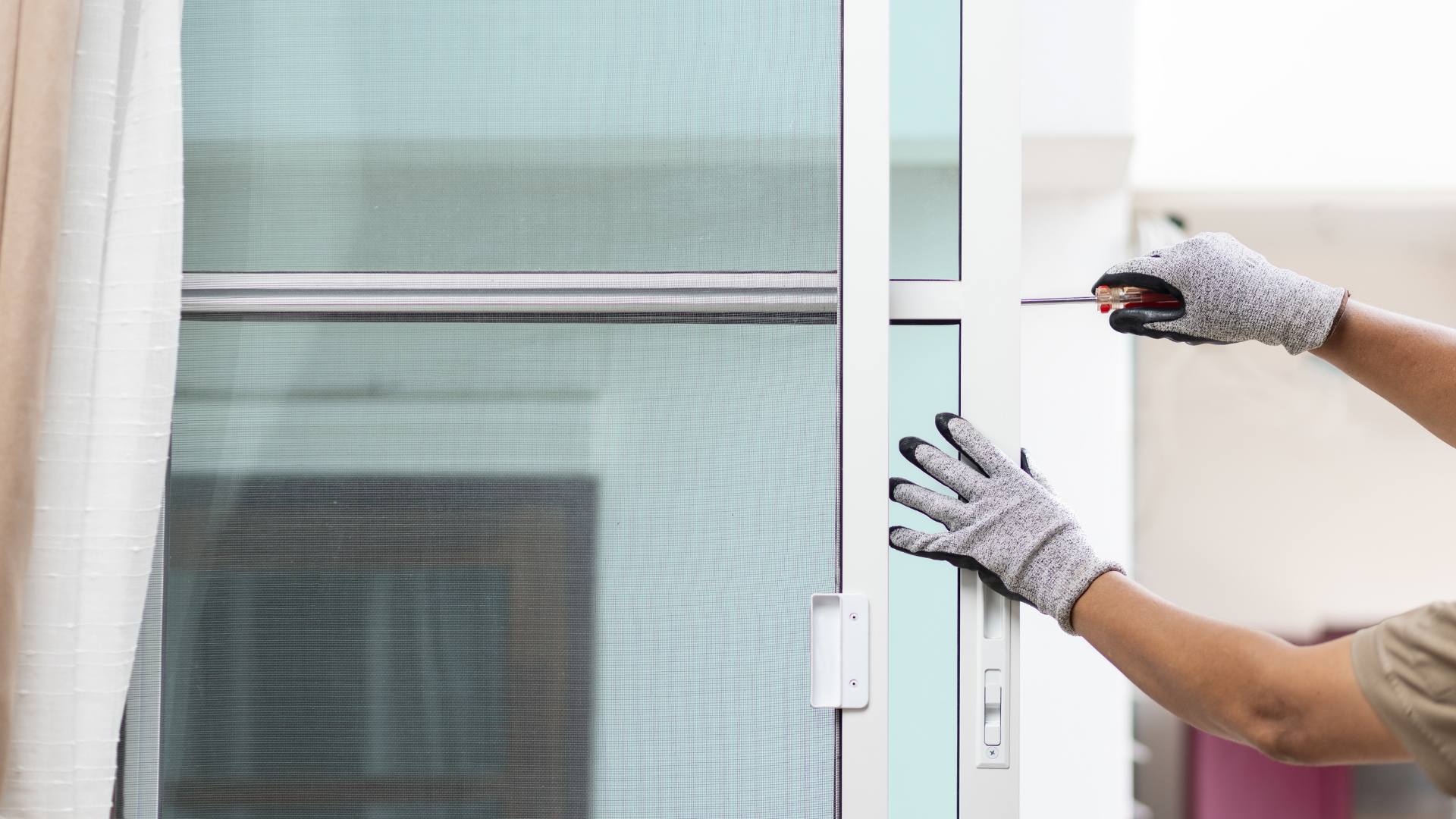 Close-up of hands cleaning a freshly installed glass pane