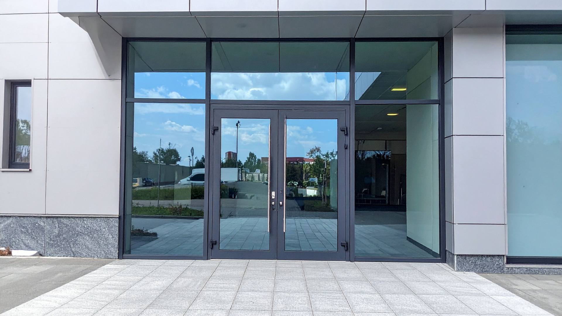 Modern glass storefront with display windows and entry doors